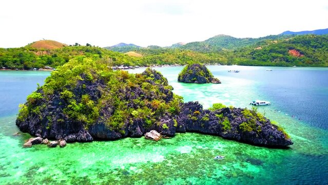 Aerial: Nautical Vessels Floating On Rippled Sea, Drone Flying Forward Over Green Rock Formations During Sunny Day - Palawan, Philippines