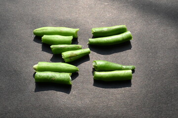 Green beans on black background. Its other names names French beans, string beans, snap beans, snaps, and the French name haricot vert. Popular vegetable of all over world. 
