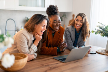 Group of happy business women working together in a home office.