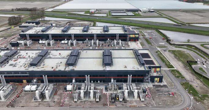 Datacenters Wieringermeer, construction of a large new datacenter in The Netherlands, Agriport business park in Hollands Kroon. Internet infrastructure and cloud services. Aerial drone view.
