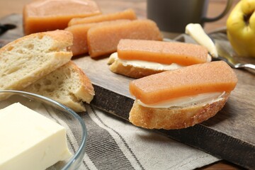 Quince paste sandwiches and fresh fruit on table, closeup