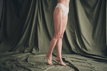 Unretouched cropped photo of old lady wear white panties step isolated green color linen background