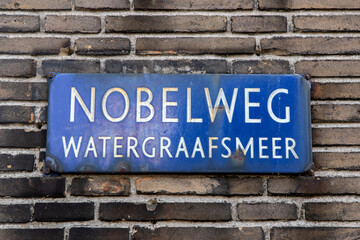 Fototapeta na wymiar Street Sign Nobelweg At Amsterdam The Netherlands 12-4-2024