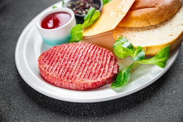 burger set raw cutlet, bun, cheese, tomato sauce, greens fresh cooking appetizer meal food snack on the table copy space food background rustic