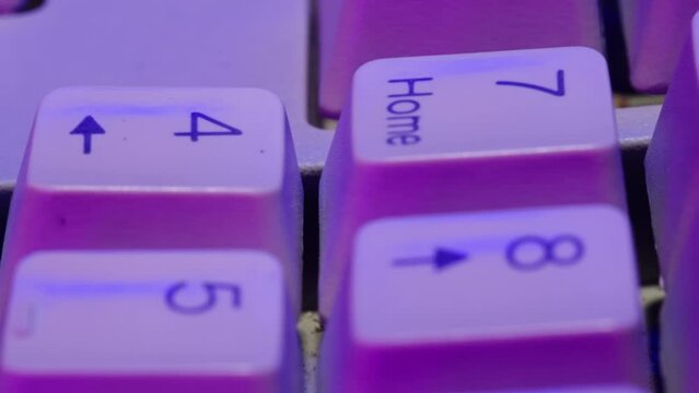 Old vintage keyboard retro pc close-up in neon light , Old computer studio close-up, Desktop vintage retro wave display, late 90s PC.
