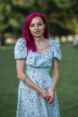 Fototapeta premium Portrait of a young beautiful red-haired girl outdoors.