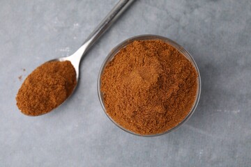 Ground red pepper on grey table, top view