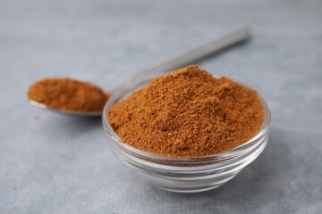 Ground red pepper on grey table, closeup