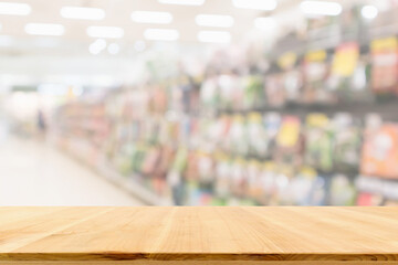 Naklejka na ściany i meble Empty wood table top with supermarket blurred background for product display