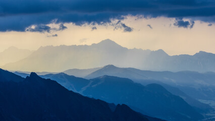 Mountain landscape in mystic mood with storm clouds and sunrays. Hohe Tauern mountain range in...