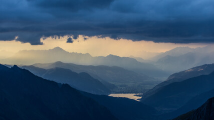 Dark storm clouds over the Hohe Tauern mountain range in Austria. Mystic mood with mountain layers...