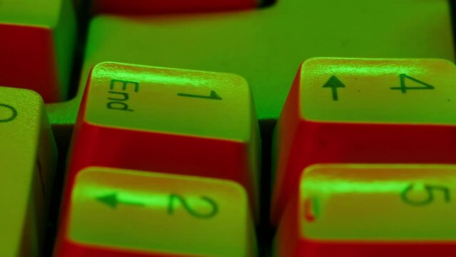 Old vintage keyboard retro pc close-up in neon light , Old computer studio close-up, Desktop vintage retro wave display, late 90s PC.