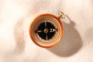 Compass on sand, top view. Navigation equipment