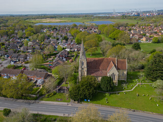 Marchwood church in the spring. Aerial view of the church yards and Marchwood village towards solar farm and Southampton container terminal.