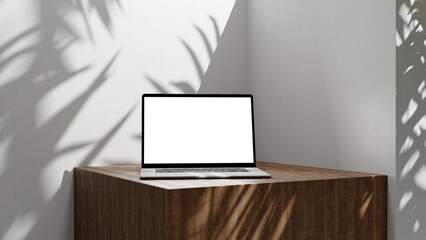 Laptop summer office mock up with sun light and palm leafs shadows. laptop with clean blank screen for design and advertisement, laptop on wooden table on white walls background with white screen
