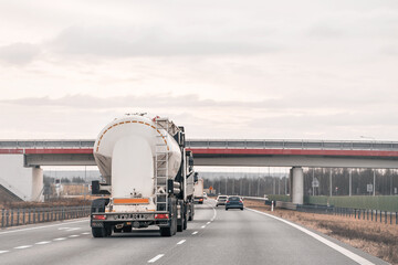 Petrochemical Products in Transit. Fuel Tanker Journey Along the Asphalt Trails and Suburban areas.