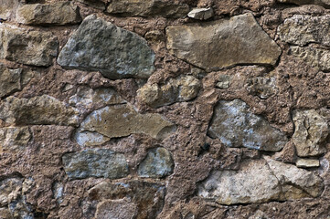 in the photo there is a close-up of an old stone wall