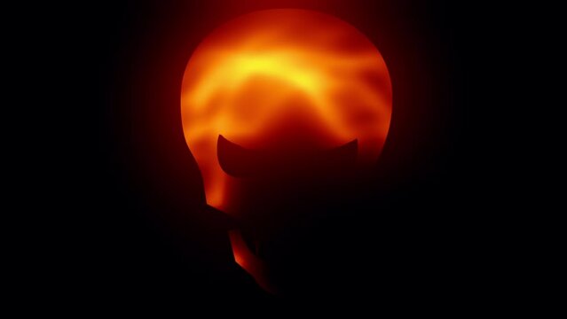 Evil skull face with fire glow on dark background 
