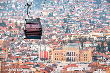 the beauty of Sarajevo's skyline from above as you journey through the cityscape in a cable car, passing over the rooftops and town hall. - 786495209