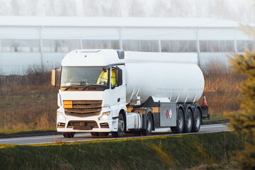 Automotive fuel tankers shipping fuel. Isothermal Tank truck driving on a highway. - obrazy, fototapety, plakaty