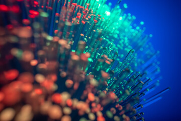 Conceptual multicolored image with short focal length fiber optic network cable for fast communication. Blue background, macro. - obrazy, fototapety, plakaty