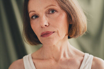 Unretouched photo of attractive old woman look camera isolated green color linen background