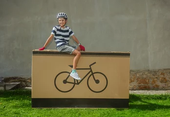 Foto op Canvas Grinning teenager cyclist posing on large bike-icon package © Sergey Novikov