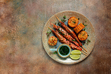 langoustines on skewers, shrimp kebab, with fried corn, spices and herbs, homemade, no people,
