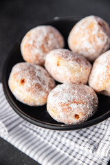 donut filled with powdered sugar.chocolate filling.fresh cooking.appetizer meal food snack on the table copy space food background rustic