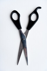 Sewing scissors on a white background. Green scissors.