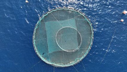 Aerial drone photo of latest technology self feeding fish farming unit of sea bream and sea bass in Mediterranean calm deep blue sea