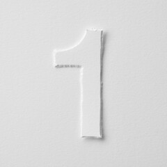 The number one is made of white paper on a white background.