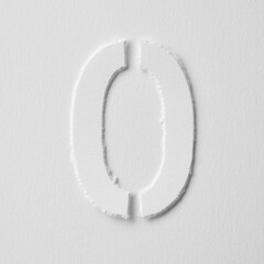 The number zero is made of white paper on a white background.