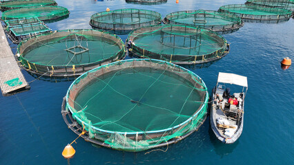 Aerial drone photo of latest technology self feeding fish farming unit of sea bream and sea bass in...