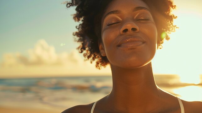 Peaceful black woman enjoying sun light at the beach - Beautiful female breathing fresh air outside - Health care and wellness concept 