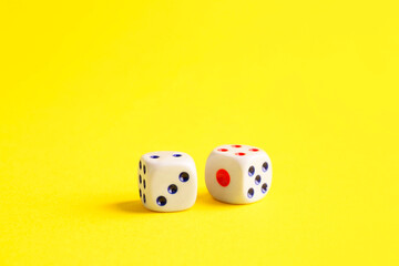 Two white game dices on yellow background