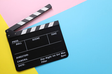 Fototapeta na wymiar Clapperboard on color background, top view. Space for text