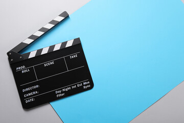 Fototapeta na wymiar Clapperboard on color background, top view. Space for text