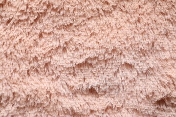 Texture of pink faux fur as background, closeup