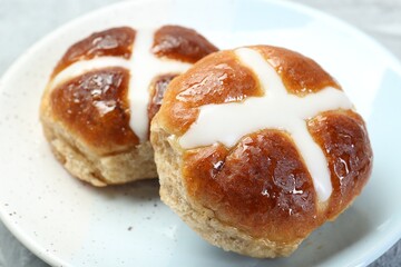 Tasty hot cross buns on table, closeup