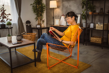 one female mature japanese woman read book at home