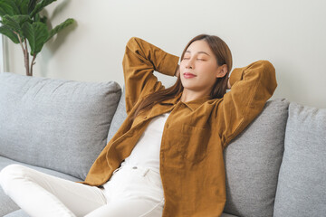 Relaxed serene, happy calm attractive asian young woman peace of mind, relaxing on comfortable...