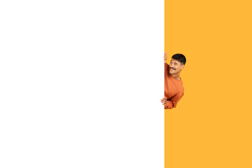 Man peeking out from behind a blank banner