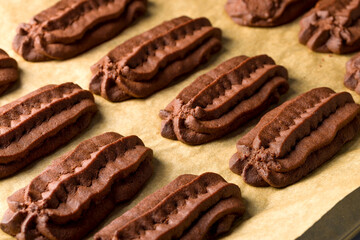 Chocolate shortbread cookies. Light background.