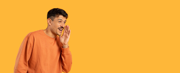 Man whispering a secret on orange background