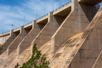 Close side bottom view of a dry concrete river dam from below