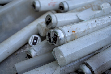 Fluorescent lamps thrown into a landfill