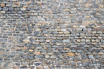 Rough ancient grey brick masonry wall texture background