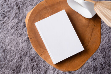 blank book mockup on coffee table with decorations and grey rug