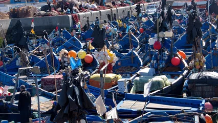 Fotobehang Fishing boats, with colorful floats for the fishing nets, moored in the marina at the port in Essaouira, Morocco © Angela
